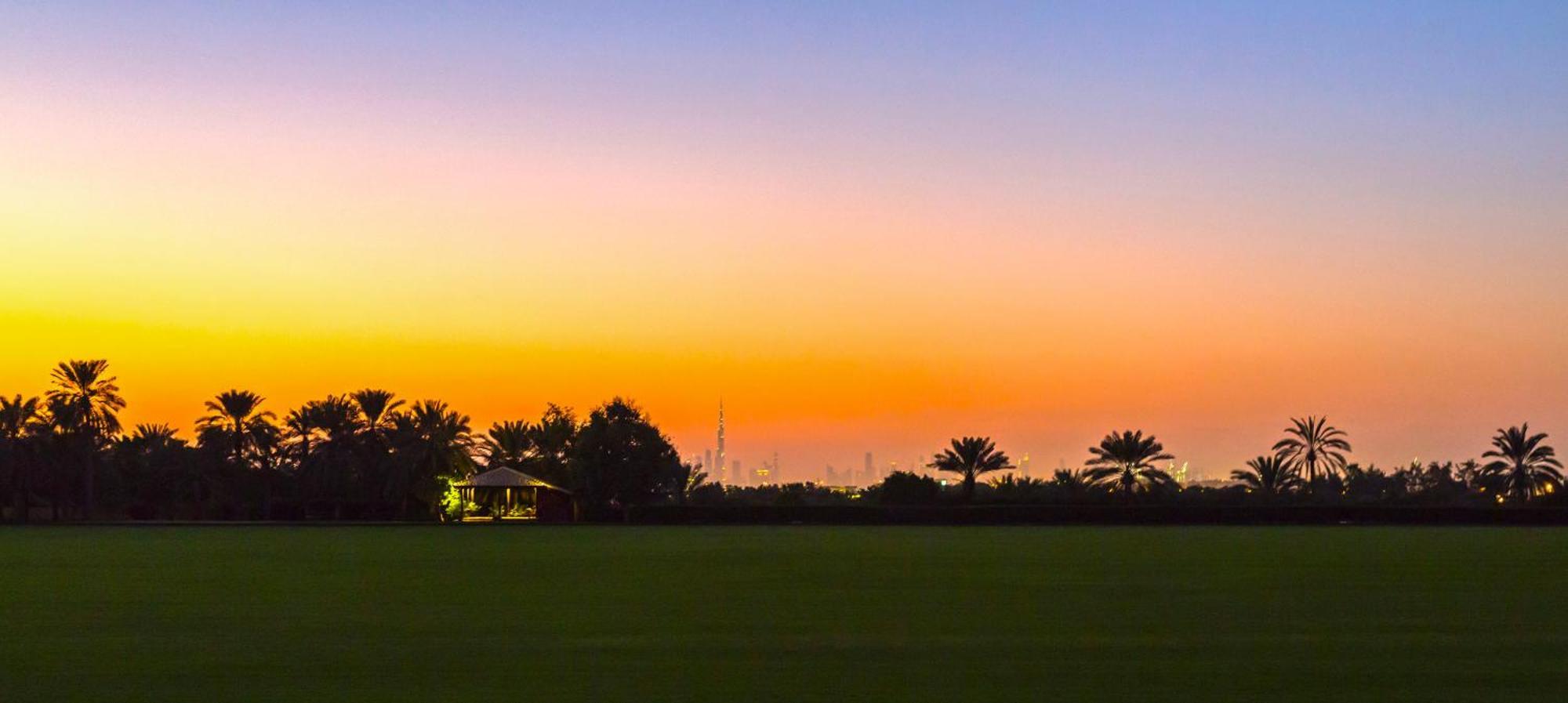 Melia Desert Palm Member Of Melia Collection Dubai Exterior photo Sunset over Al-Qusais